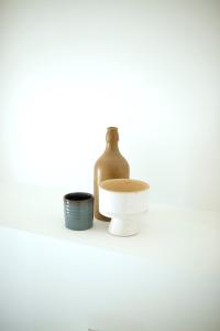 a bottle and two bowls sitting on a shelf at Appartement - Loft Le Cosy in Hyères