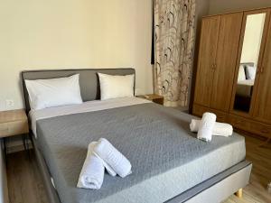 a bedroom with a bed with two towels on it at Irini Panorama in Agia Galini