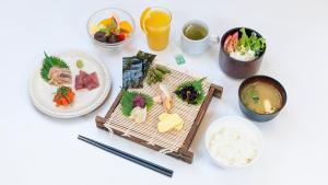 a white table topped with plates of food and drinks at ibis Styles Kyoto Station in Kyoto