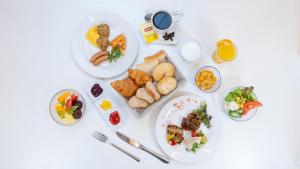 a white table with plates of food in the shape of a heart at ibis Styles Kyoto Station in Kyoto
