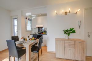 a kitchen and dining room with a table and chairs at Lean Home - Happy Rentals in Lugano