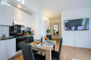 a kitchen with a table with a bowl of fruit on it at Lean Home - Happy Rentals in Lugano