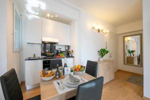 a kitchen with a table with bowls of fruit on it at Lean Home - Happy Rentals in Lugano