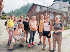 a group of people standing in front of a building at Tongfu Inn(In the National Park) in Zhangjiajie