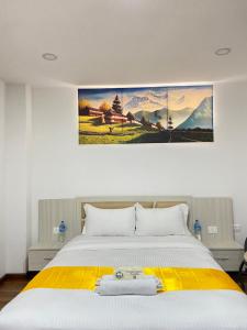 a bedroom with a large bed with a yellow blanket at Himalayan laligurans Hospitality in Kathmandu