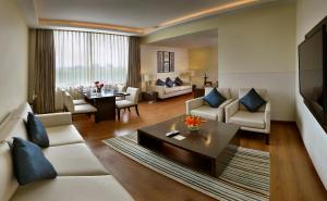 新德里的住宿－尼達拉德里酒店，客厅配有沙发和桌子