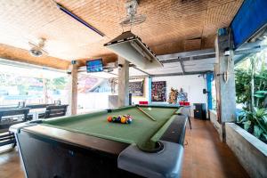 a pool table in a room with a pool at Bodega Koh Pha Ngan Pool in Baan Tai