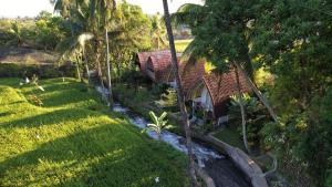 an aerial view of a house and a yard at Damuh Pertivi in Lovina