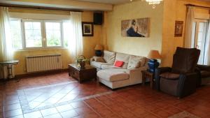 a living room with a couch and two chairs at Hosteria De Langre in Langre