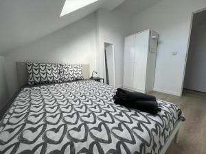 a bedroom with a bed with a black and white bedspread at Schaerbeek Room 2 in Brussels
