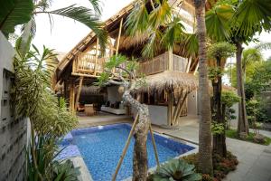 a villa with a swimming pool and a resort at The Kharma Villas Yogyakarta in Yogyakarta