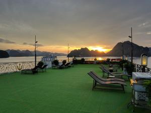 a group of chairs sitting on the deck of a boat at La Renta Premium Cruise in Ha Long
