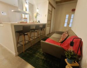 a living room with a couch and a kitchen at Private rooms in Gothic in Barcelona