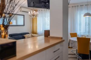 a kitchen and living room with a couch and a table at Apartment Tree Of Life in Kaštela