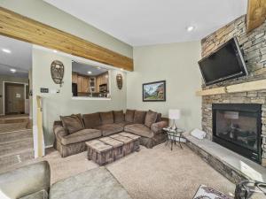 a living room with a couch and a fireplace at Woods25 Townhome Condo in Copper Mountain
