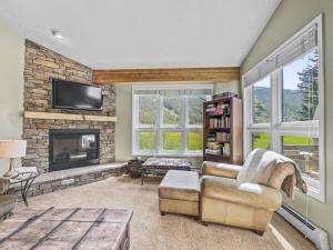 a living room with a couch and a fireplace at Woods25 Townhome Condo in Copper Mountain