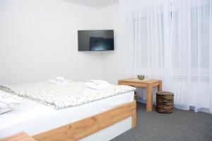a bedroom with a bed and a television on the wall at Apartman City Peace Sarajevo, 72 m2, free parking in Sarajevo