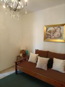 a couch in a living room with a picture of a baby at Akademia House - Santarém in Santarém