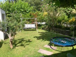 a garden with a swing in the grass at Location Eyheraldia votre Triplex au cœur du Pays Basque in Hasparren +21 photos