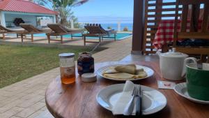 a table with a plate of food and a drink at Nosy Bay View in Nosy Be