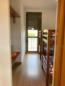 a room with a hallway with bunk beds and a door at Albergue Valmadrid 
