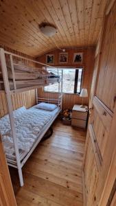 a room with two bunk beds in a cabin at Thingvellir Lake Cottage in Veiðilundur