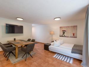 a hotel room with a bed and a table and chairs at Appartements Wanner in Gerlos