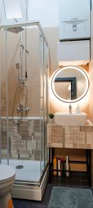 a bathroom with a glass shower and a sink at Apartman City Peace Sarajevo, 72 m2, free parking in Sarajevo +28 photos