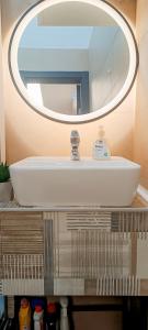 a bathroom sink with a large mirror above it at Apartman City Peace Sarajevo, 72 m2, free parking in Sarajevo