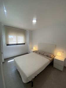 Ένα ή περισσότερα κρεβάτια σε δωμάτιο στο Apartamentos CorteInglés Castellón