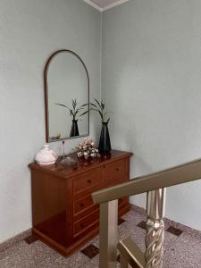 a room with a dresser with a mirror on it at Hotel La Pergola in Rionero in Vulture