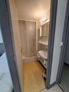 a small bathroom with a sink and a toilet at Hôtel Les Mouflons in Le Mont-Dore +72 photos