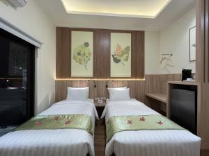 Postel nebo postele na pokoji v ubytování D'Bamboo Suites