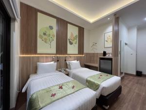 Postel nebo postele na pokoji v ubytování D'Bamboo Suites