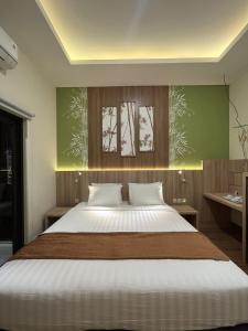 Postel nebo postele na pokoji v ubytování D'Bamboo Suites
