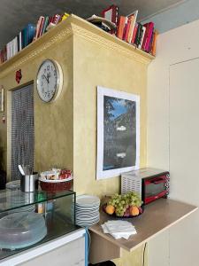 a kitchen with a counter with a clock on the wall at Hotel La Pergola in Rionero in Vulture