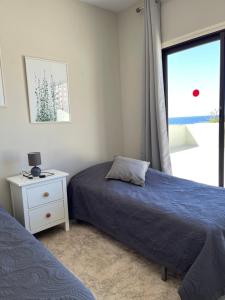 a bedroom with two beds and a window at Bahia I in Puerto de la Cruz