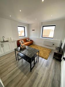 a living room with a table and a couch at Stylish City Centre Flat in Norwich