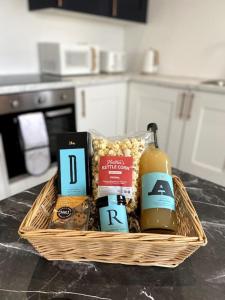 a basket of food and drinks on a counter at Stylish City Centre Flat in Norwich