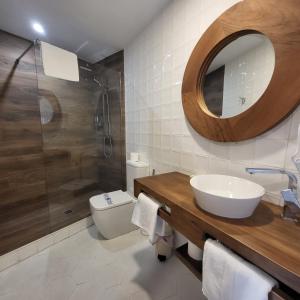 a bathroom with a sink and a shower and a toilet at Hostal El Cerro - Only Adults in Pedro Bernardo