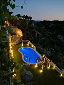 an overhead view of a swimming pool at night at Hostal El Cerro - Only Adults in Pedro Bernardo