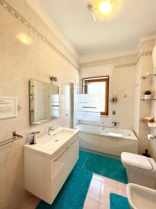 a bathroom with a sink and a tub and a toilet at B&B Le Saline in Taranto