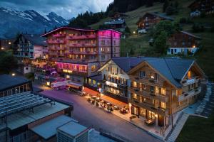 a hotel in a mountain town at night at Eiger Guesthouse in Mürren