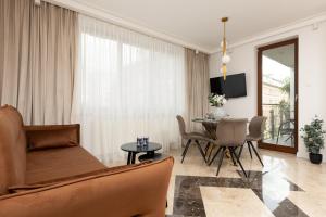 a living room with a couch and a table at Elegant Mokotow Apartment with Parking & AC near Royal Baths Warsaw by Renters Prestige in Warsaw