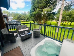 a deck with a jacuzzi tub on a porch at Hideaway Retreat with Hot Tub in York