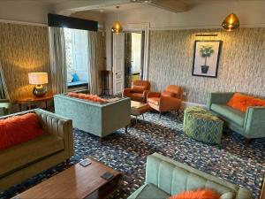 a living room with couches and chairs at Moresby Hall Country House Hotel in Whitehaven