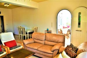 a living room with a couch and a table at Ioanna's Villa 10 minutes walking from sea in Gra Liyiá