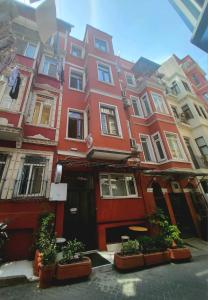 a red building with plants in front of it at taksim 34 apart istanbul in Istanbul