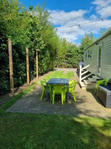 a patio with a table and a trailer at 24 Chestnut Grove Caravan in Humberston