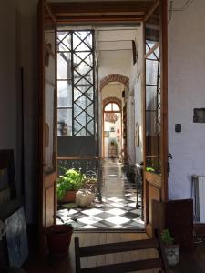 an open door of a building with a checkered floor at casa vegana in Montevideo